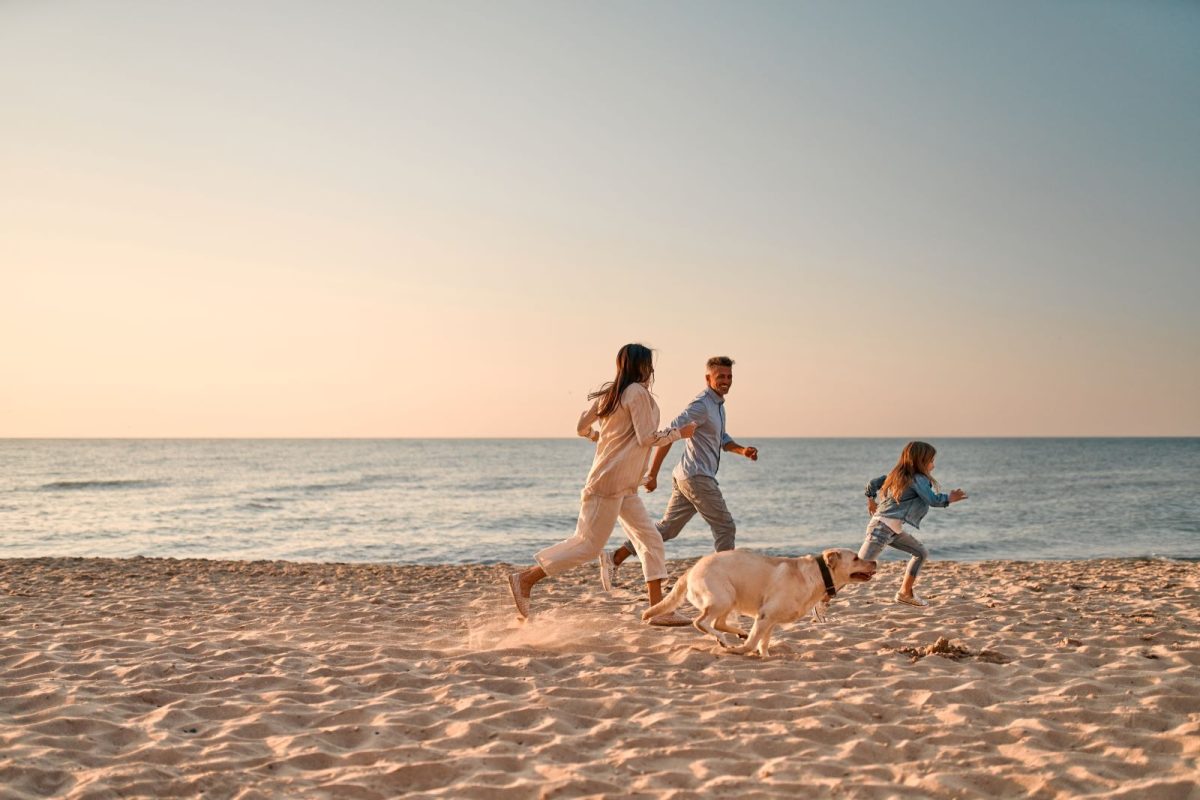 Family running on beach
