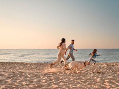 friendly family running on the beach