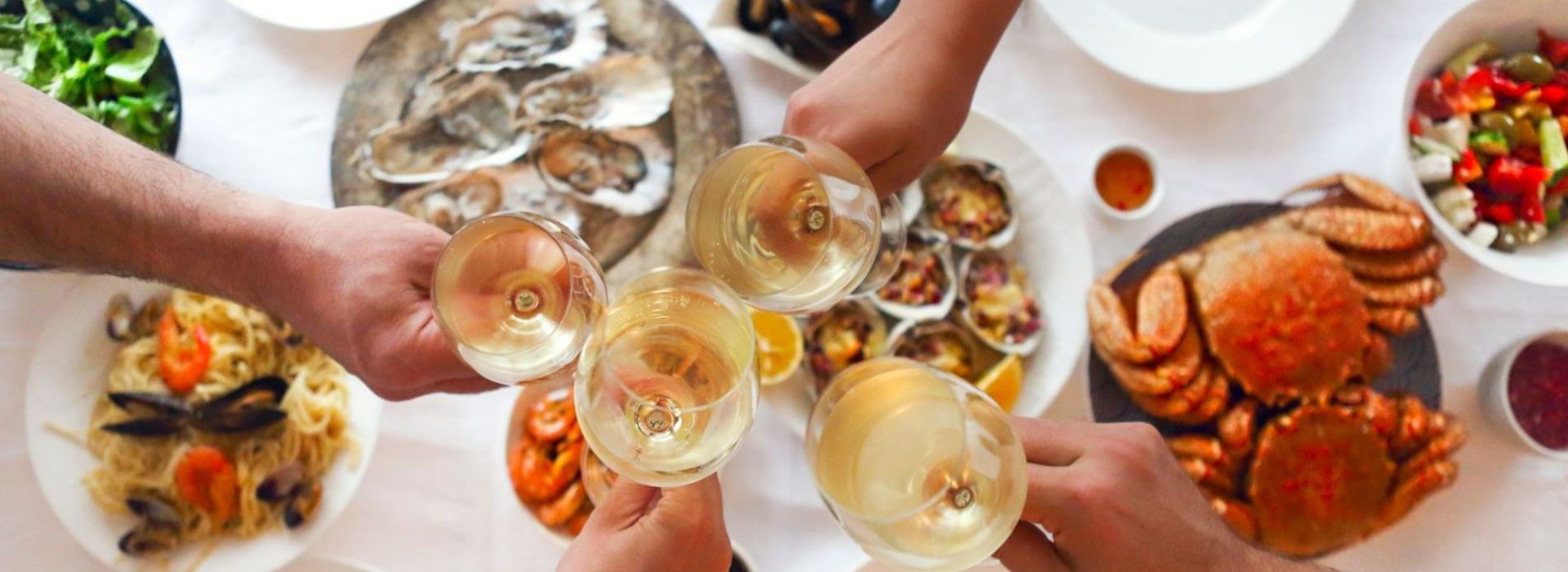 group toasting glasses at dinner