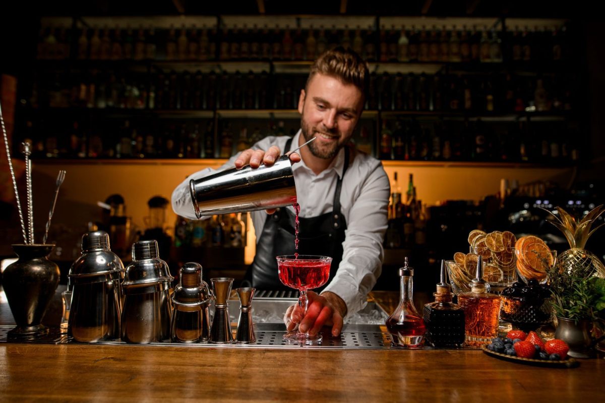 bar tender pouring cocktail