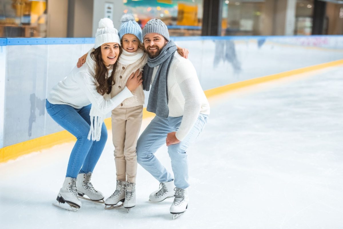 Family posing for a picture while ice skating