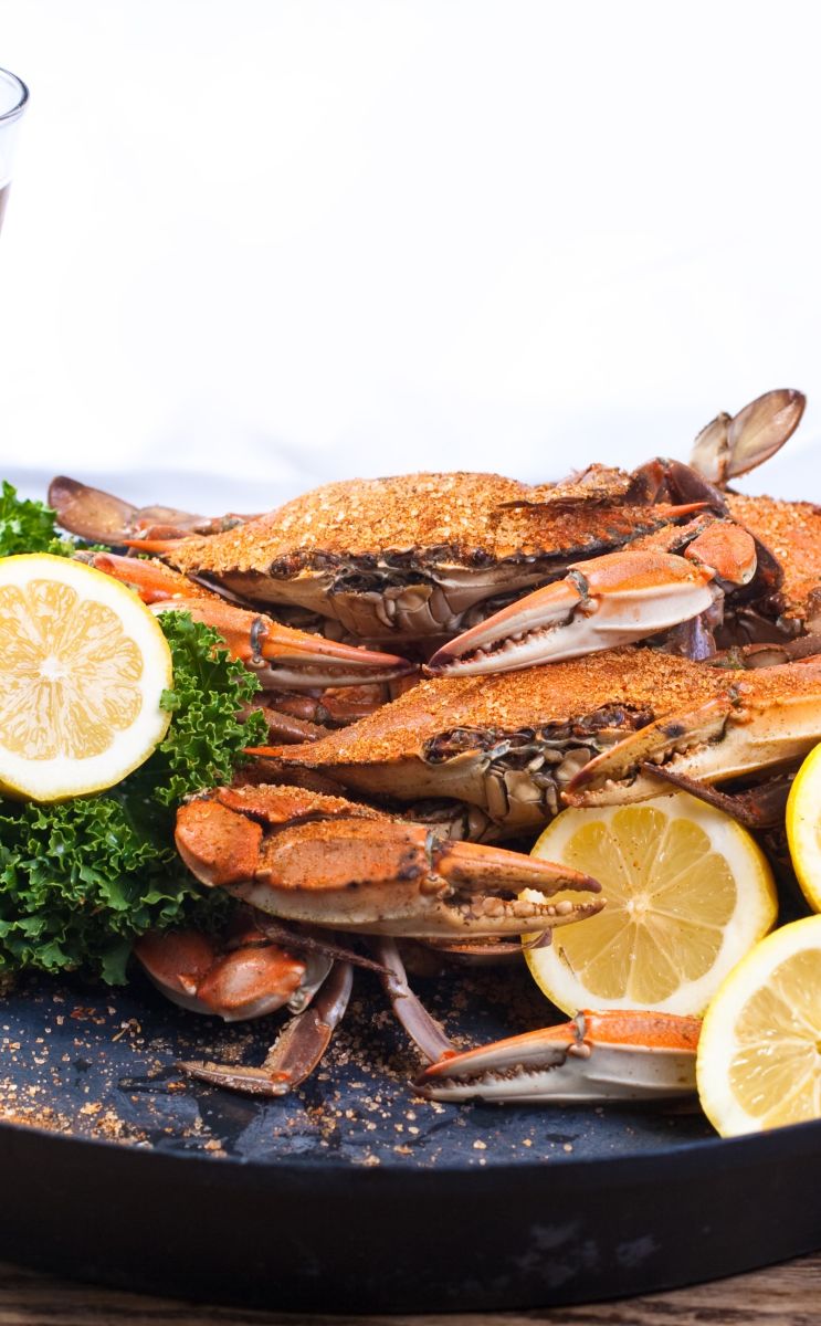 a plate of crabs and lemons at a restaurant table in ocean city